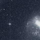 The Transiting Exoplanet Survey Satellite (TESS) took this snapshot of the Large Magellanic Cloud (right) and the bright star R Doradus (left) with just a single detector of one of its cameras on Tuesday, Aug. 7. The frame is part of a swath of the southern sky TESS captured in its “first light” science image as part of its initial round of data collection.